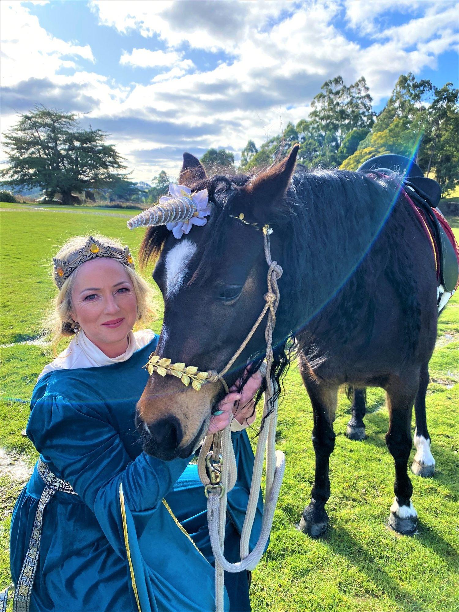 The founder of Little Letter Pony Pals with a pony in a sunlit paddock